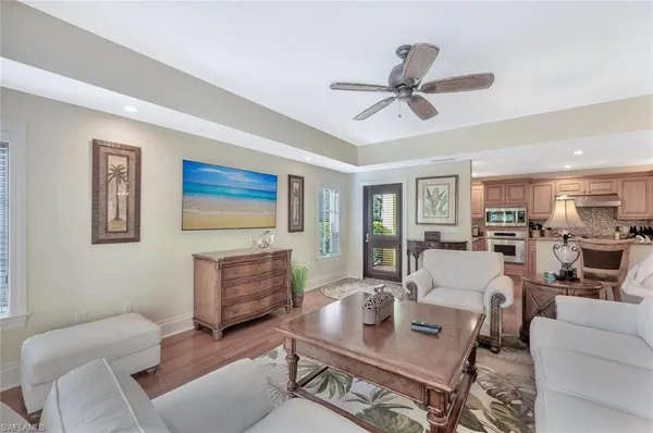 a living room with furniture and a view of kitchen
