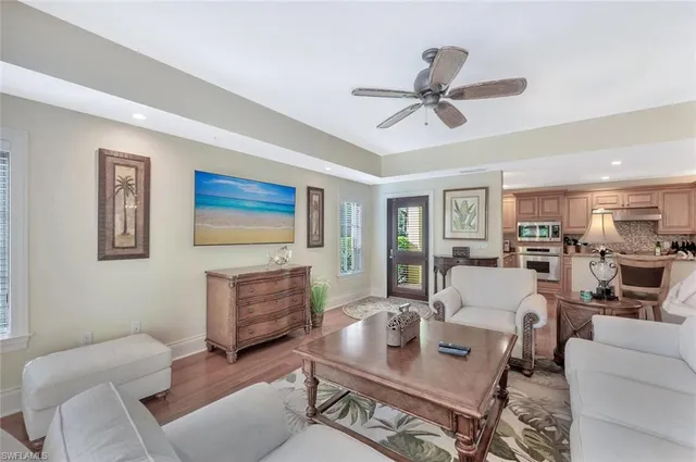 a living room with furniture and a view of kitchen