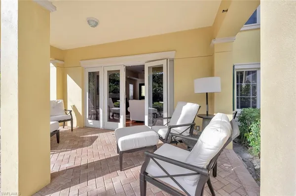 a view of a patio with table and chairs and potted plants