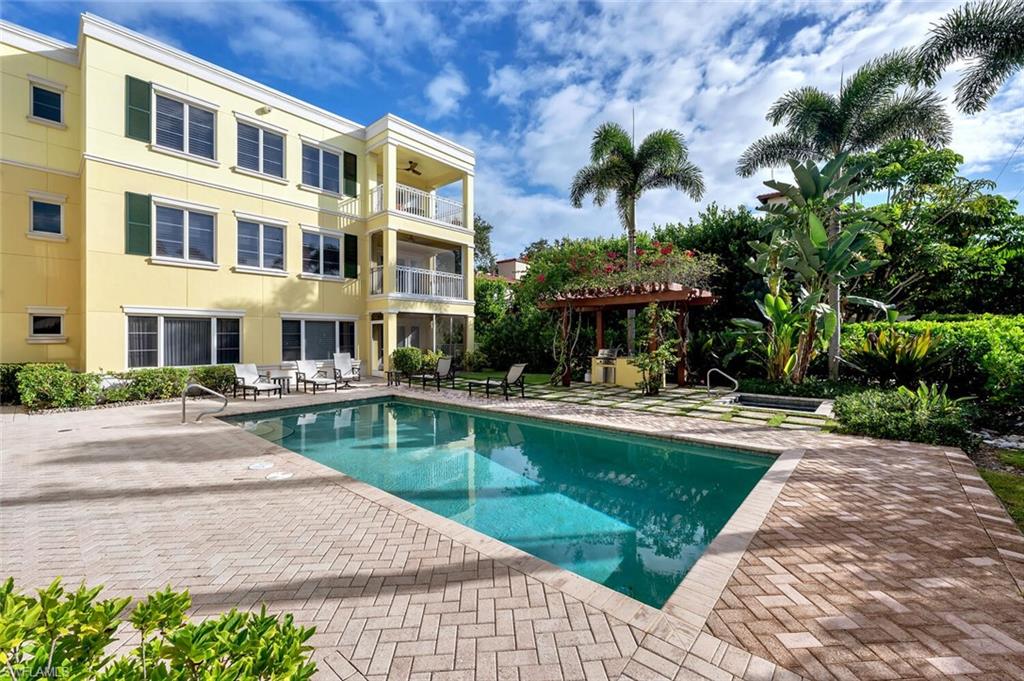 325 3rd Street South, Unit 6 Naples, FL 34102 - Photo 34 of 36 a view of a swimming pool with a patio