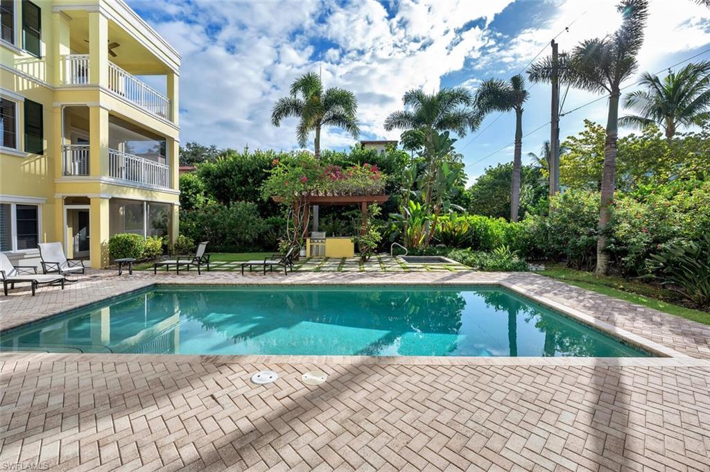325 3rd Street South, Unit 6 Naples, FL 34102 - Photo 35 of 36 a swimming pool with outdoor seating and yard