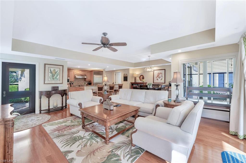 325 3rd Street South, Unit 6 Naples, FL 34102 - Photo 4 of 36 a living room with furniture and a wooden floor