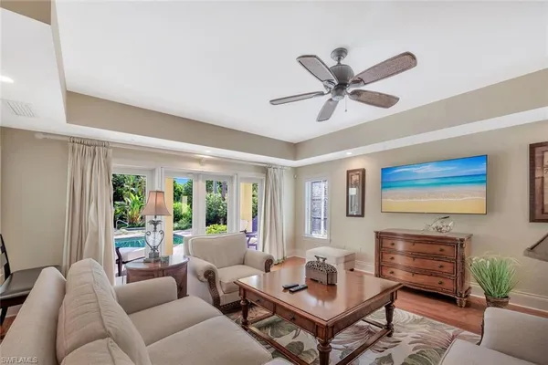 a living room with furniture a fireplace and a large window