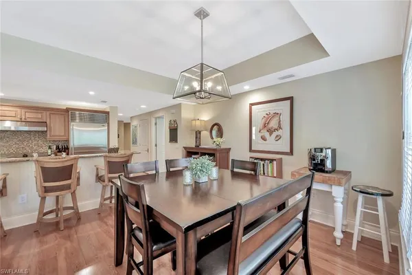 a view of a dining room with furniture wooden floor and chandelier