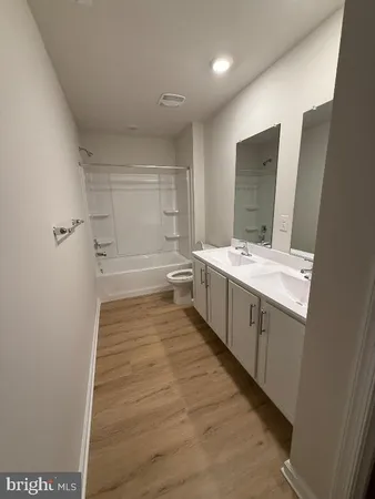 a bathroom with a sink a large mirror and a bathtub