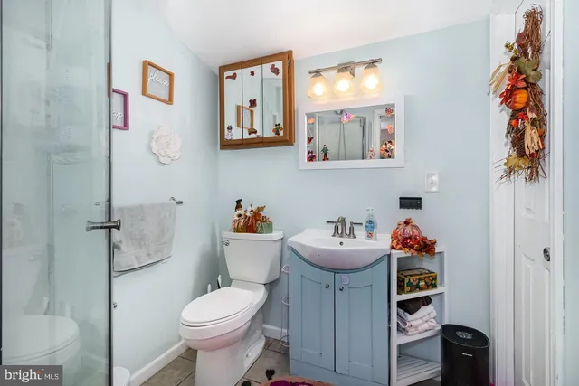 a white toilet sitting next to a bathroom sink