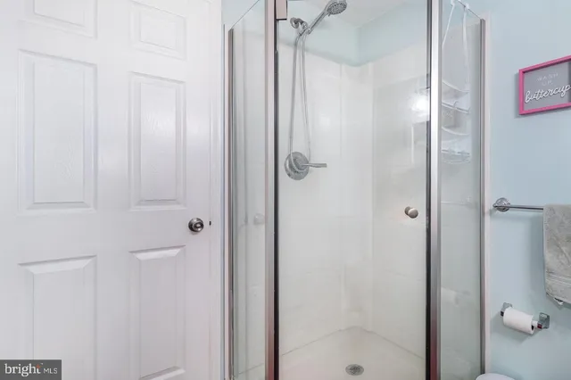 a bathroom with a glass shower door