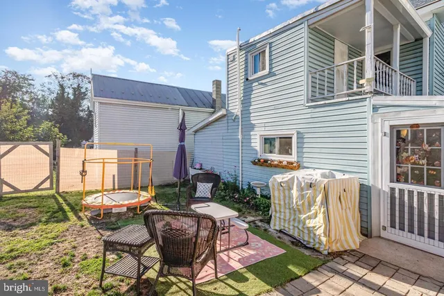 a view of a chairs and table in backyard of the house