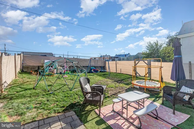 a view of a backyard with sitting area