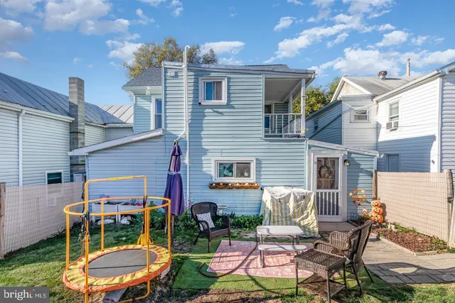 a view of a chairs and table in backyard of the house