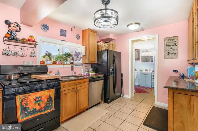 a kitchen with stainless steel appliances granite countertop a stove a refrigerator a sink and dishwasher