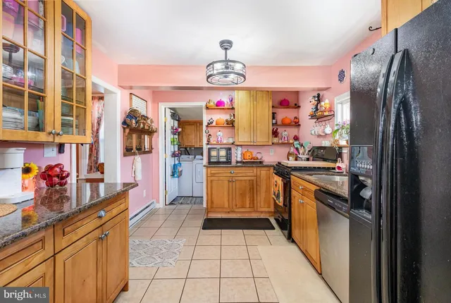 a kitchen with stainless steel appliances granite countertop a refrigerator and a stove