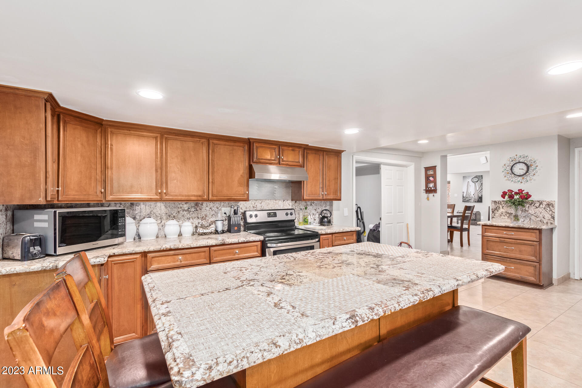 3834 North 34th Street Phoenix, AZ 85018 - Photo 11 of 29 a view of a kitchen with kitchen island a large counter top space appliances and cabinets