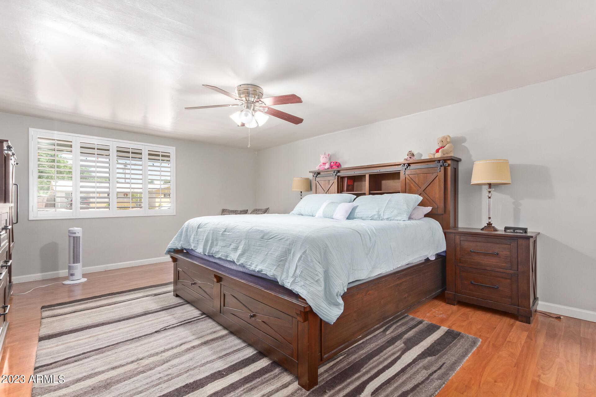 3834 North 34th Street Phoenix, AZ 85018 - Photo 14 of 29 a bed room with a bed and a chandelier