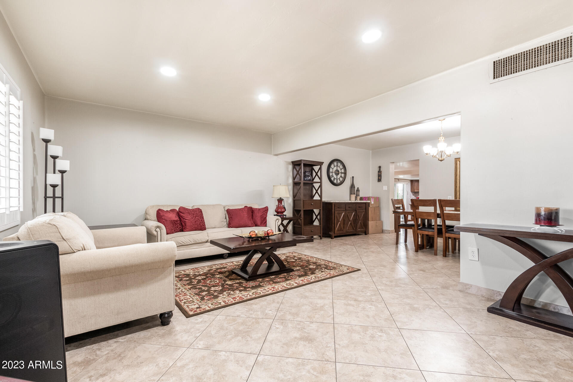 3834 North 34th Street Phoenix, AZ 85018 - Photo 4 of 29 a living room with furniture and a dining table with kitchen view