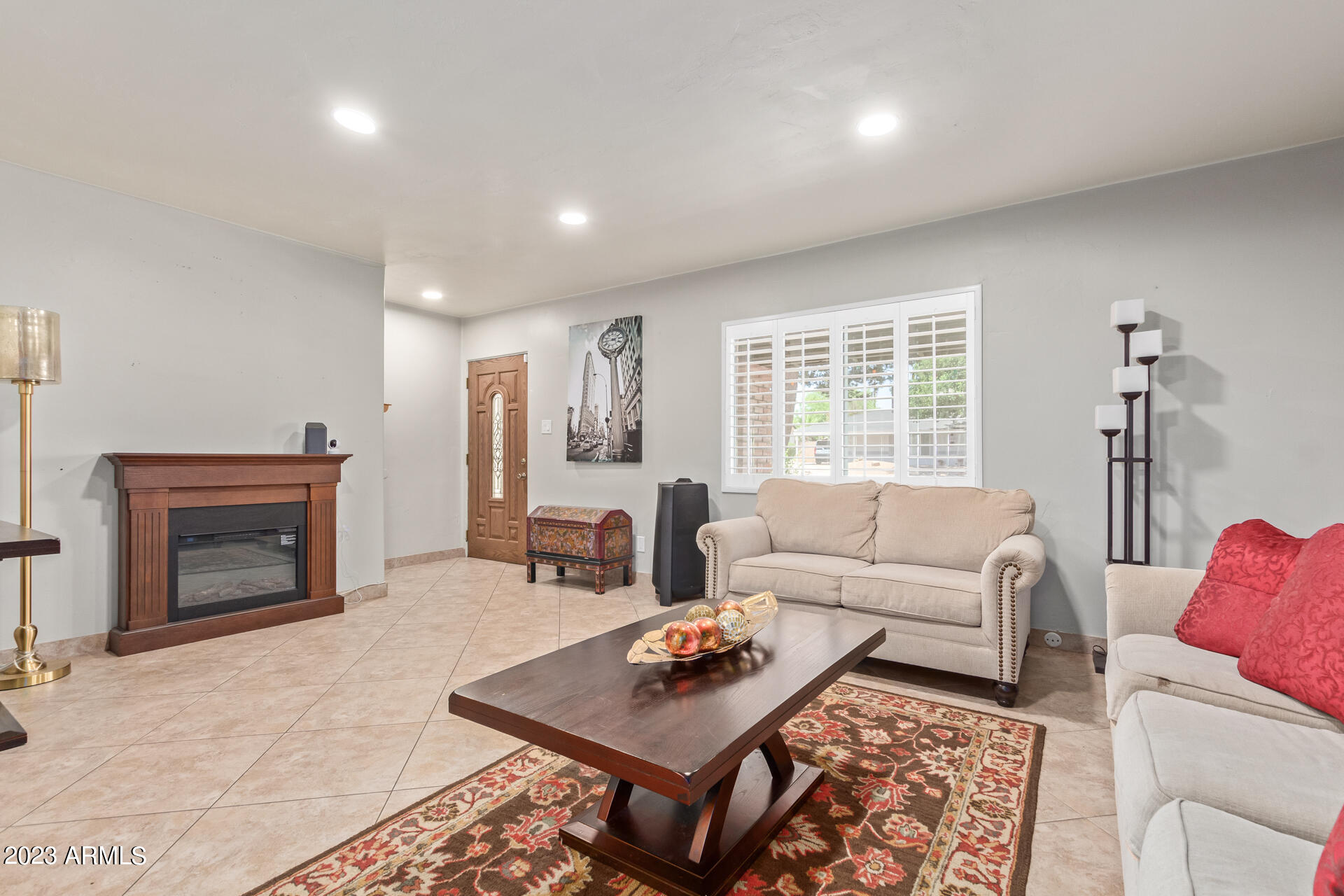 3834 North 34th Street Phoenix, AZ 85018 - Photo 5 of 29 a living room with furniture a fireplace and a table
