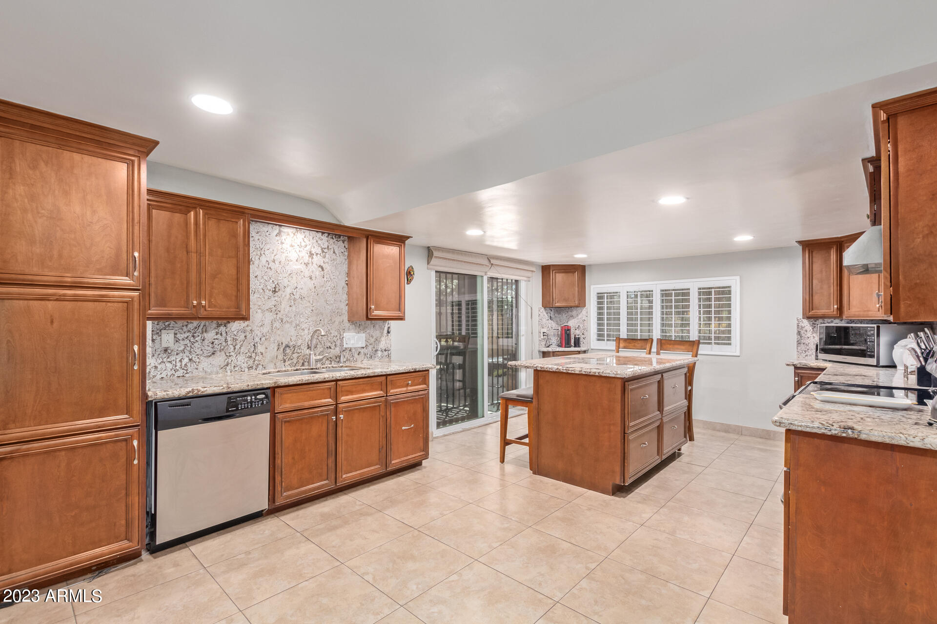 3834 North 34th Street Phoenix, AZ 85018 - Photo 7 of 29 a large kitchen with stainless steel appliances granite countertop a refrigerator and a stove top oven