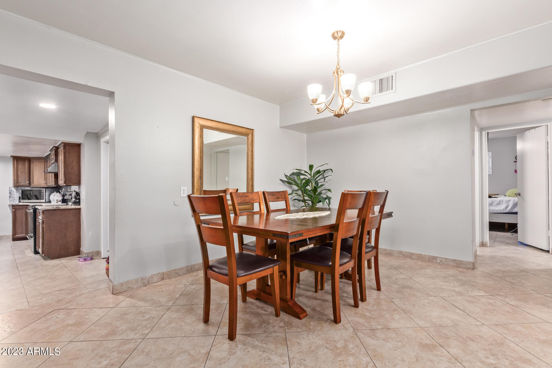 3834 North 34th Street Phoenix, AZ 85018 - Photo 8 of 29 a dining room with furniture and chandelier