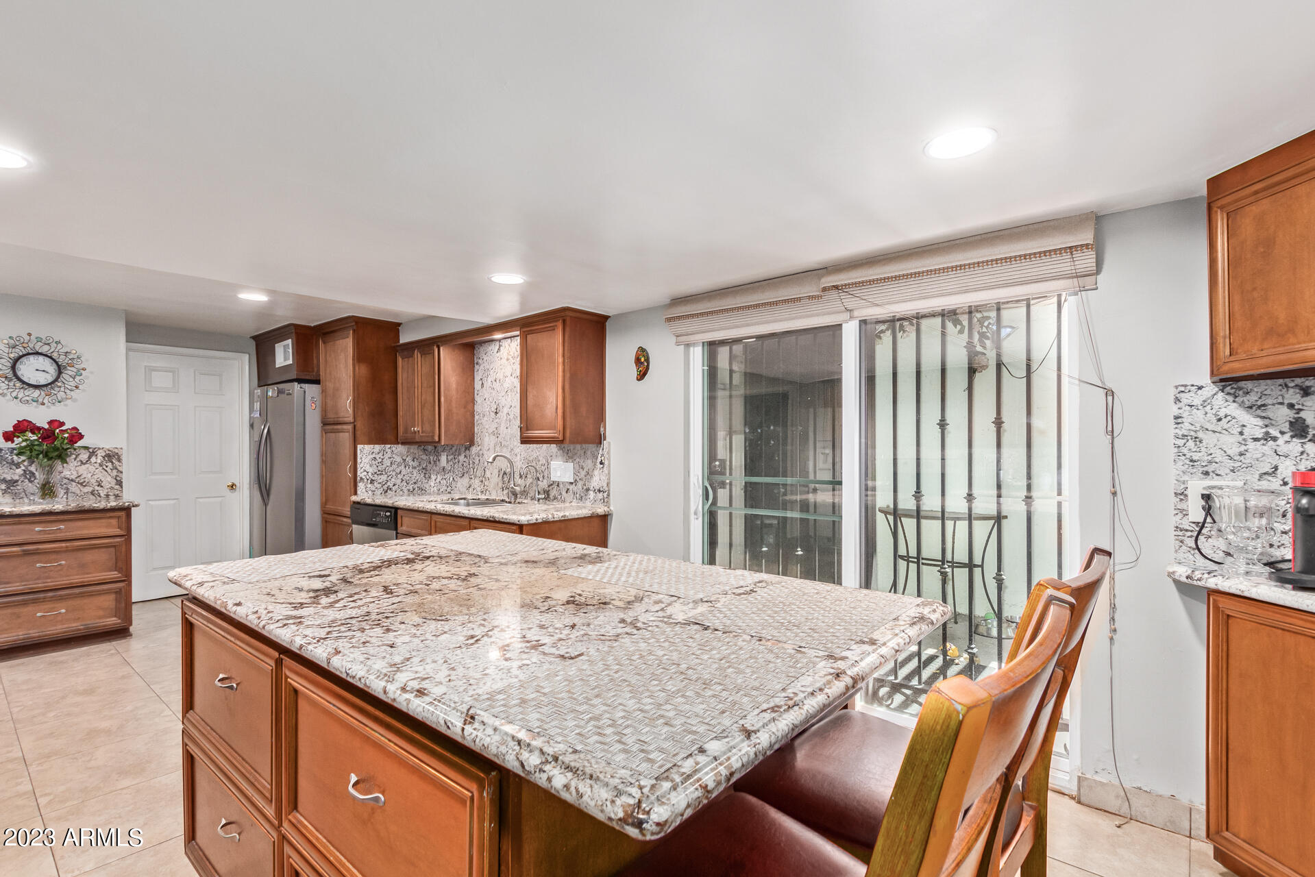 3834 North 34th Street Phoenix, AZ 85018 - Photo 10 of 29 a view of kitchen island with granite countertop wooden cabinets and couch