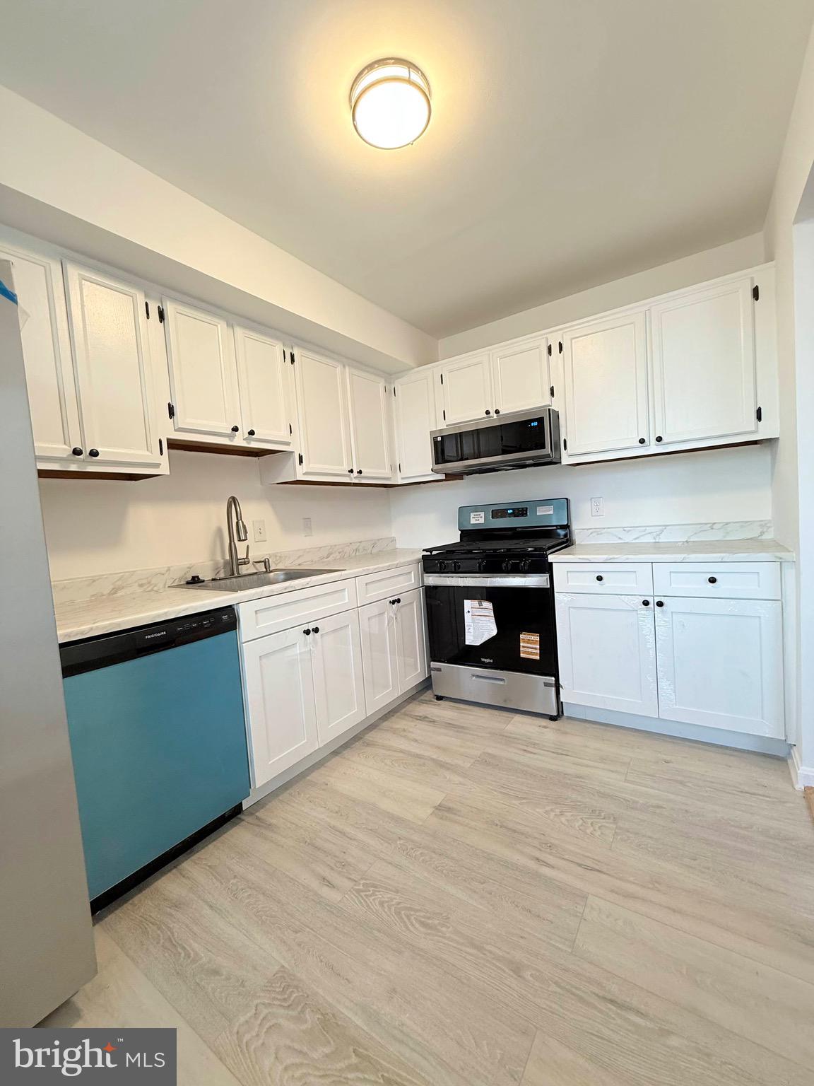 730 Quince Orchard Boulevard, Unit 730101 Gaithersburg, MD 20878 - Photo 15 of 47 a kitchen with cabinets stainless steel appliances and a window