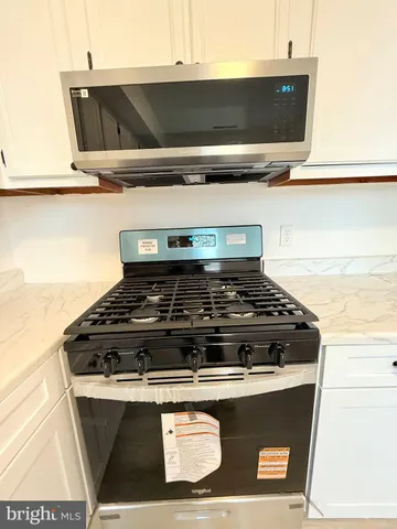a stove top oven with a sink