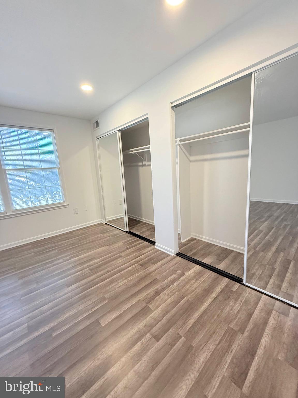730 Quince Orchard Boulevard, Unit 730101 Gaithersburg, MD 20878 - Photo 18 of 47 a view of empty room with wooden floor
