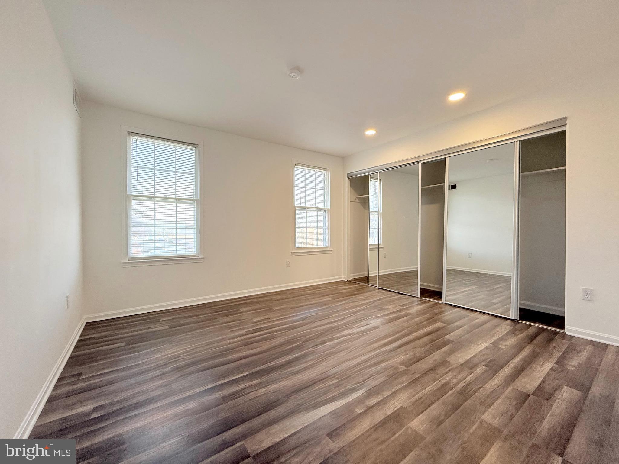730 Quince Orchard Boulevard, Unit 730101 Gaithersburg, MD 20878 - Photo 19 of 47 a view of an empty room with wooden floor and window