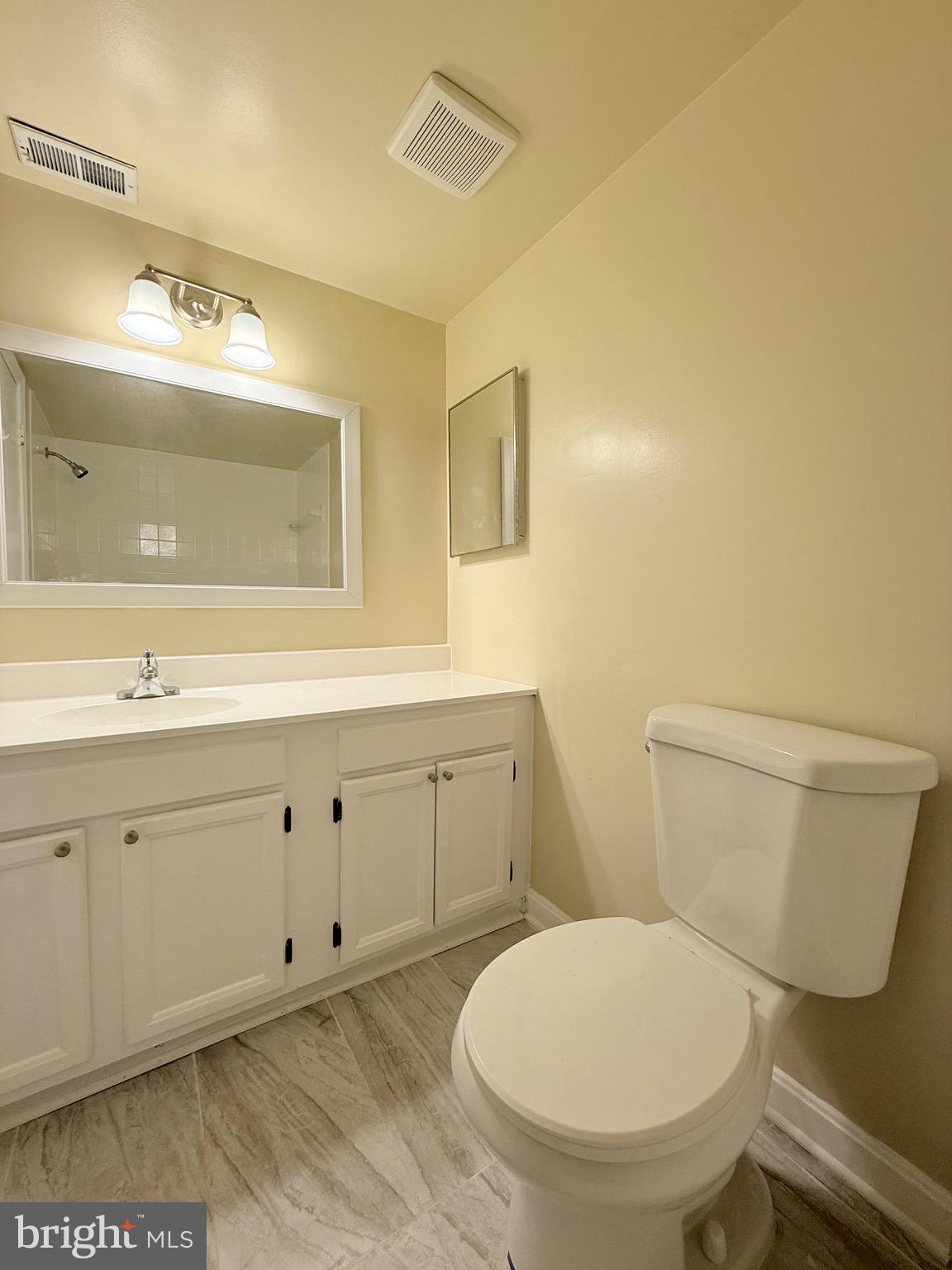 730 Quince Orchard Boulevard, Unit 730101 Gaithersburg, MD 20878 - Photo 27 of 47 a bathroom with a toilet sink and mirror