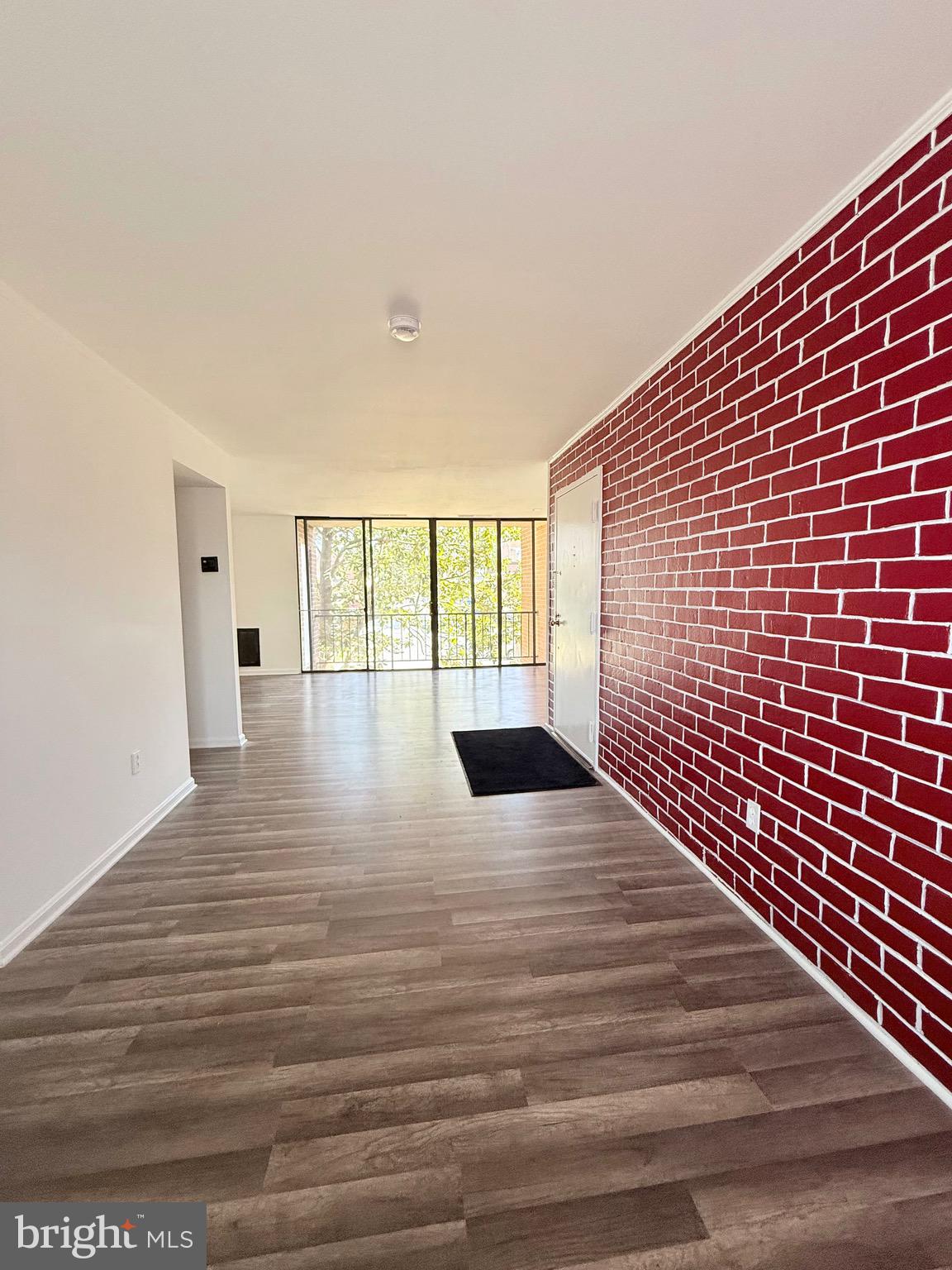 730 Quince Orchard Boulevard, Unit 730101 Gaithersburg, MD 20878 - Photo 7 of 47 a view of empty room with wooden floor