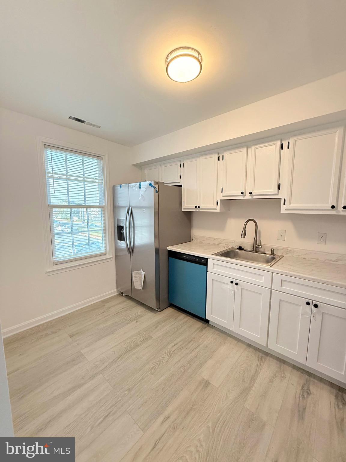 730 Quince Orchard Boulevard, Unit 730101 Gaithersburg, MD 20878 - Photo 9 of 47 a kitchen with stainless steel appliances granite countertop a stove a sink and a refrigerator
