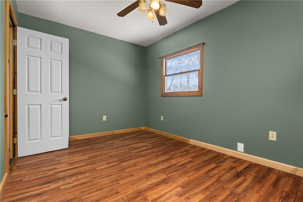 62 Allegheny Avenue Valencia, PA 16059 - Photo 17 of 30 an empty room with wooden floor chandelier fan and windows
