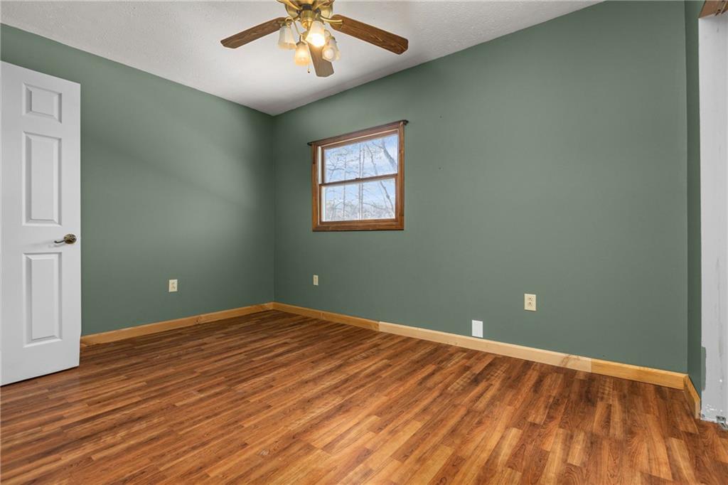 62 Allegheny Avenue Valencia, PA 16059 - Photo 18 of 30 an empty room with wooden floor chandelier fan and windows
