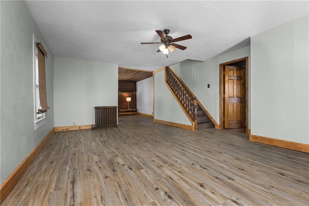 62 Allegheny Avenue Valencia, PA 16059 - Photo 10 of 30 a view of an empty room with wooden floor stairs and a chandelier fan