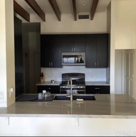 a kitchen with a refrigerator a stove and a sink