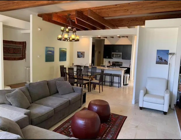 a living room with furniture and white walls