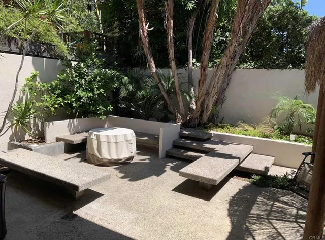 a view of a chairs and table in backyard