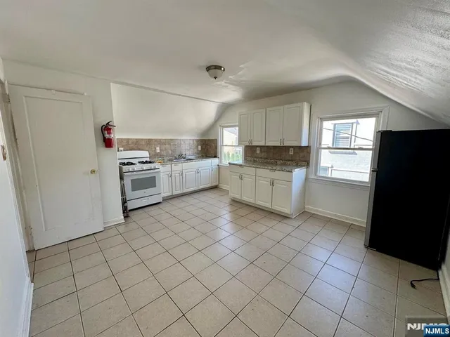 a kitchen with granite countertop cabinets and steel stainless steel appliances