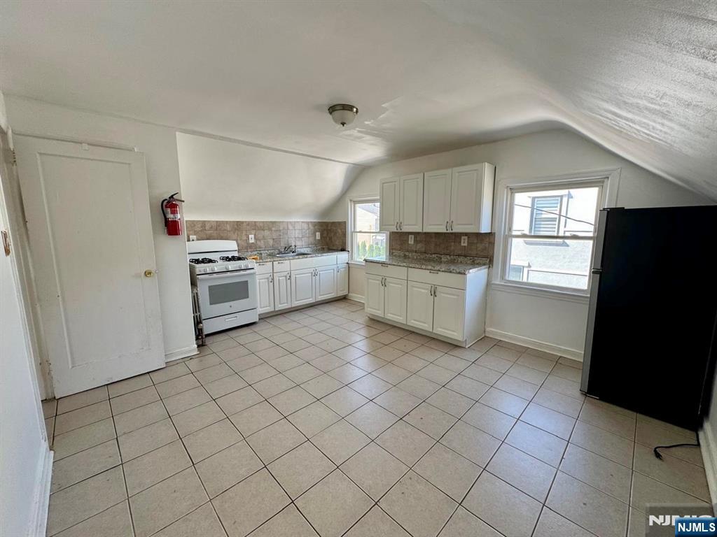 a kitchen with granite countertop cabinets and steel stainless steel appliances