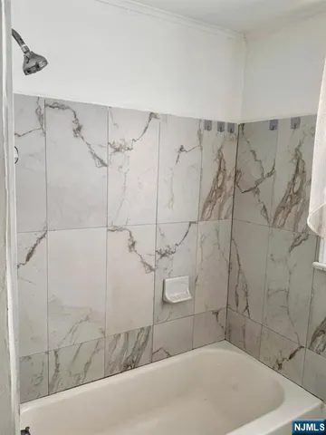 a bathroom with a bathtub and shower