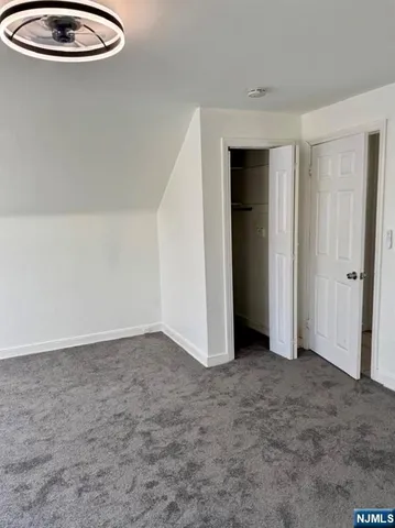 an empty room with window and stainless steel appliances