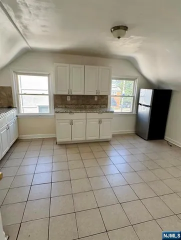 a kitchen with a sink a window and cabinets