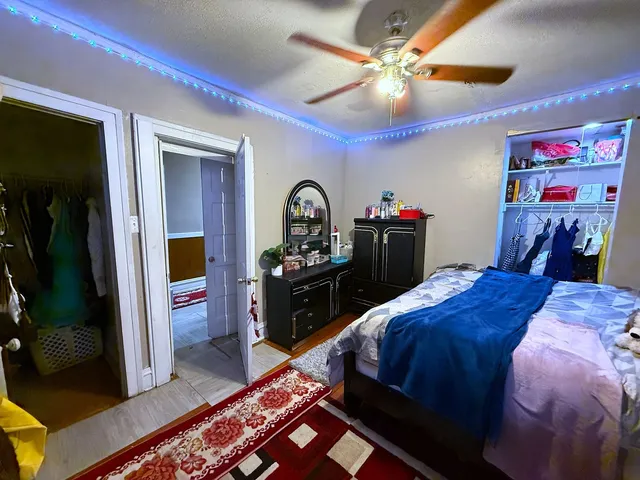 a bed room with a bed and a mirror