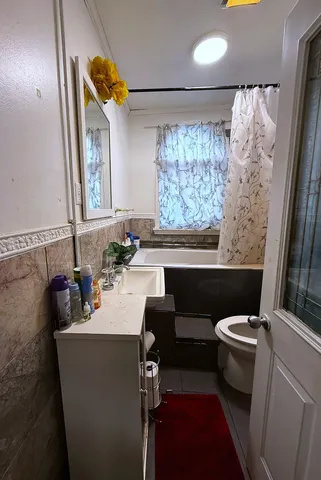 a bathroom with a sink a toilet and a mirror