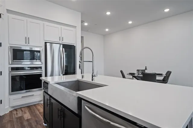 a kitchen with stainless steel appliances a stove microwave and refrigerator