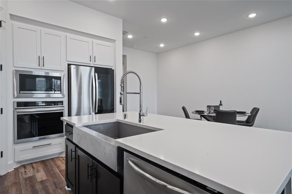 313 Sugar Maple Lane McKinney, TX 75071 - Photo 12 of 40 a kitchen with stainless steel appliances a stove microwave and refrigerator