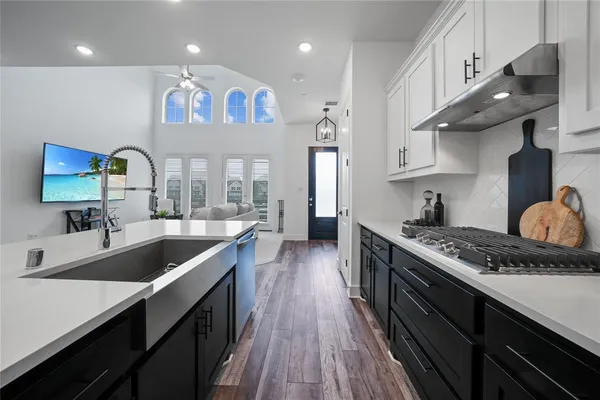 a kitchen with stainless steel appliances granite countertop a sink stove and cabinets