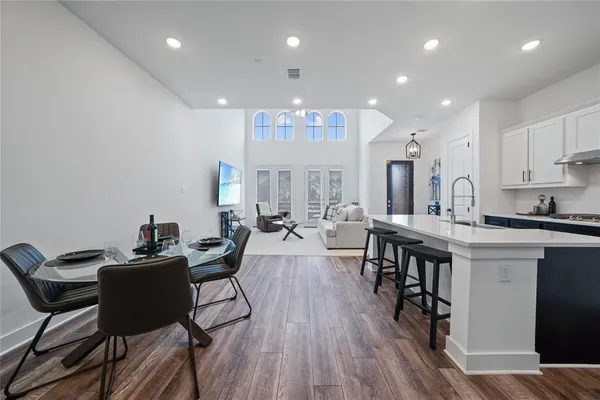 a view of a dining room with furniture and wooden floor