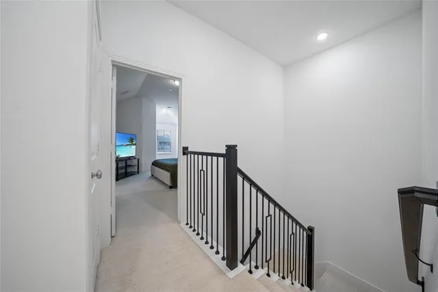 a view of a hallway with a livingroom and a window