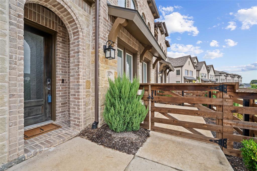 313 Sugar Maple Lane McKinney, TX 75071 - Photo 2 of 40 a view of a brick house with plants and large windows