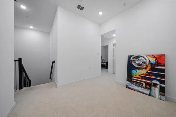 a view of an empty room and wooden floor